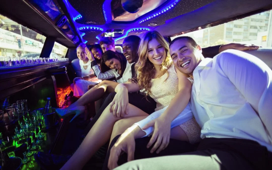 A group celebrating in the back of a limousine