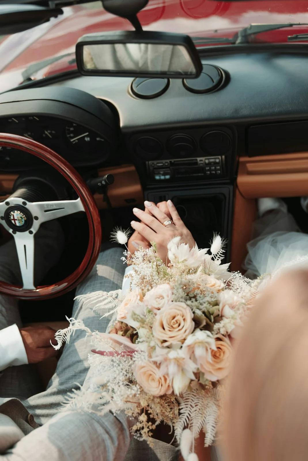 Wedding bouquet and formalwear inside a car